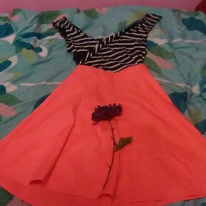 A dress with a Black and white top and orange bott